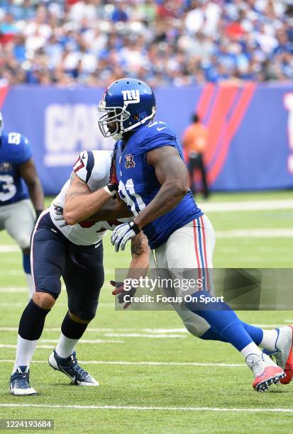 Robert Ayers of the New York Giants fights off the block of C.J. Fiedorowicz of the Houston Texans during an NFL football game September 21, 2014 at...