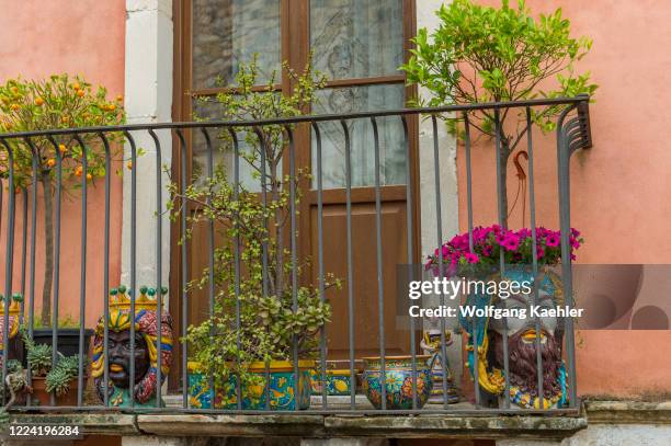 Local houses with flowers on the balconies in the small town of Taormina on the island of Sicily in Italy.