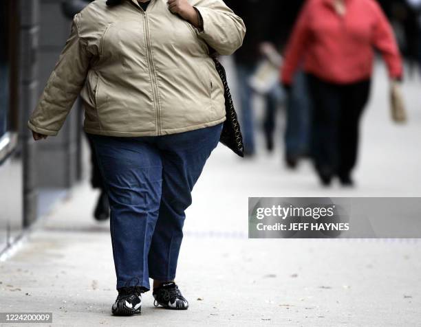 Women walks down the street on Michigan Avenue 19 October, 2006 in Chicago, Illinois. Some 2000 health experts gather in Boston, Massachusetts, on 20...