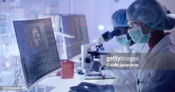 multi ethnic research team studying brainwave scanning. protective workwear - neuroscience stock pictures, royalty-free photos & images