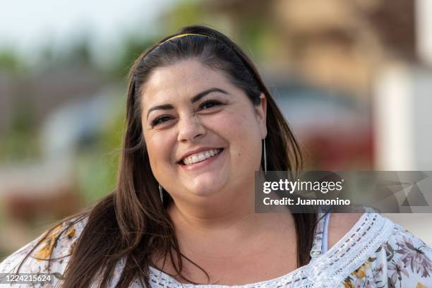 smiling overweight mediterranean woman - fat face stock pictures, royalty-free photos & images