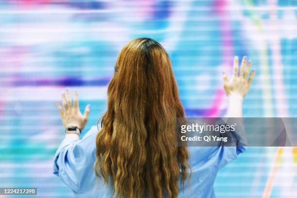 young businesswoman using a holographic screen - augmented reality marketing stock pictures, royalty-free photos & images
