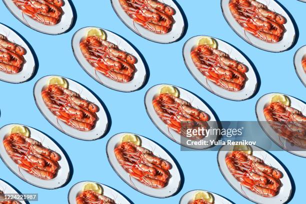 crawfish on the plate on the blue background - lobster stock pictures, royalty-free photos & images