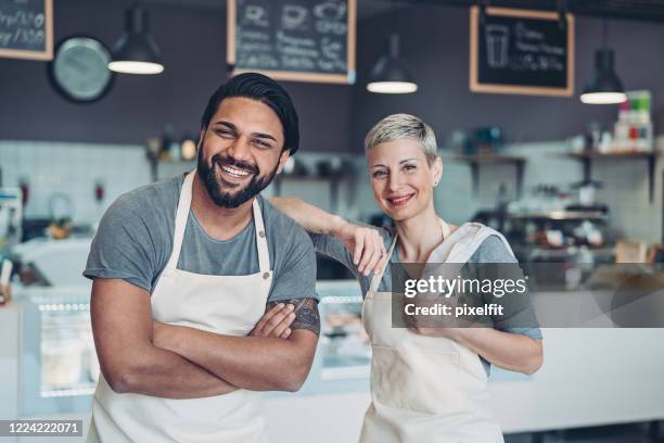 multi-ethnic couple running a business together - baker occupation stock pictures, royalty-free photos & images