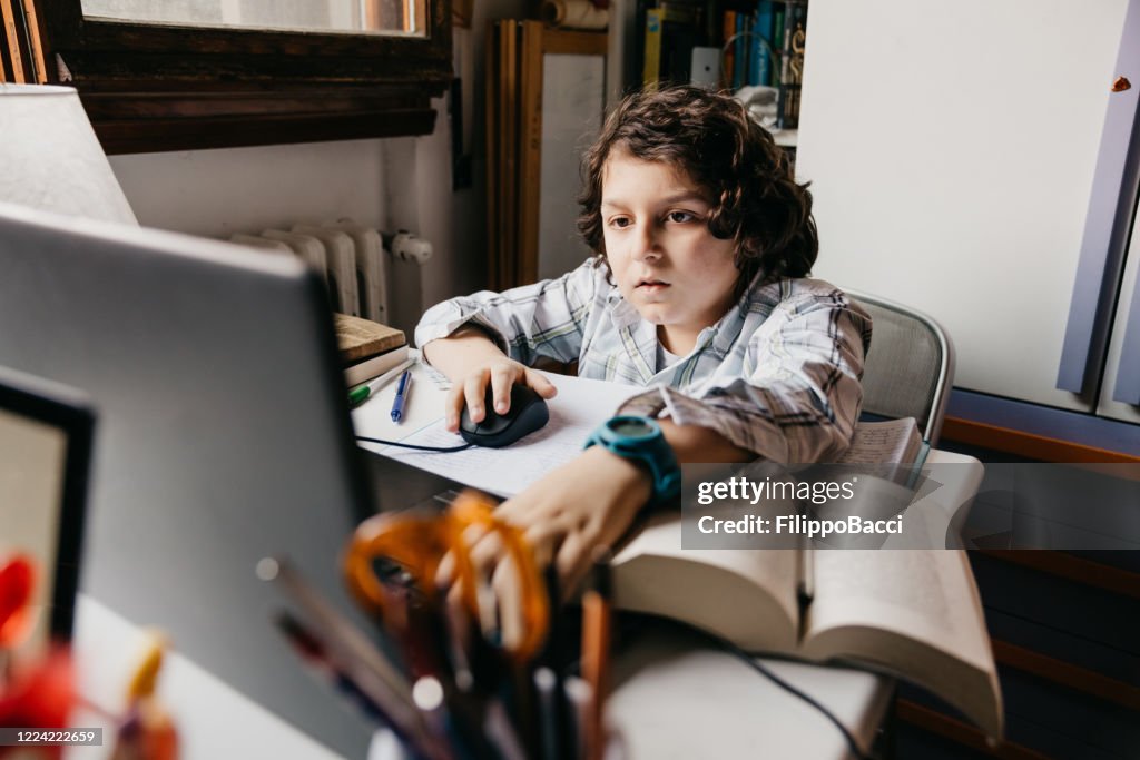 Young Boy Is Studying At Home Using A Laptop High-Res Stock Photo ...