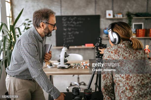 photographer recording educational video of professor for vlog on camera - vinyl film stock pictures, royalty-free photos & images