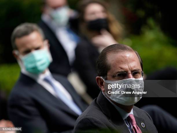 Secretary of Health and Human Services, Alex Azar and others wear face masks while attending a press briefing about coronavirus testing in the Rose...