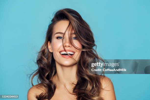 studio portrait of a beautiful girl - woman blue background stock pictures, royalty-free photos & images