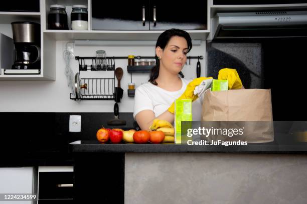woman disinfecting food in the kitchen - juice box stock pictures, royalty-free photos & images