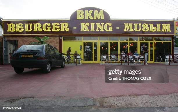 Picture taken 27 July 2005 shows clients at the terrasse of the Beurger King Muslim fast food restaurant in Clichy sous Bois, outside Paris. In this...