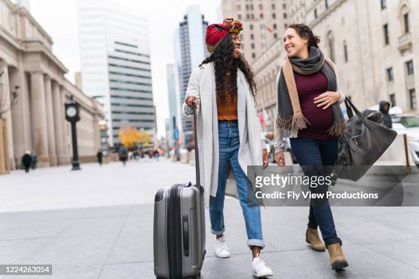 mujer embarazada con amiga que explora la ciudad mientras está de vacaciones - toronto ontario canada fotografías e imágenes de stock