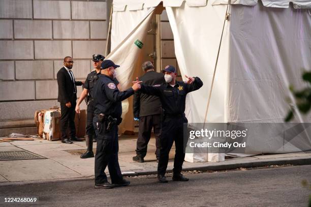 Officers exit the makeshift morgue at Lenox Hill Hospital before escorting the body of Glen Ridge New Jersey police officer Charles Roberts on May...