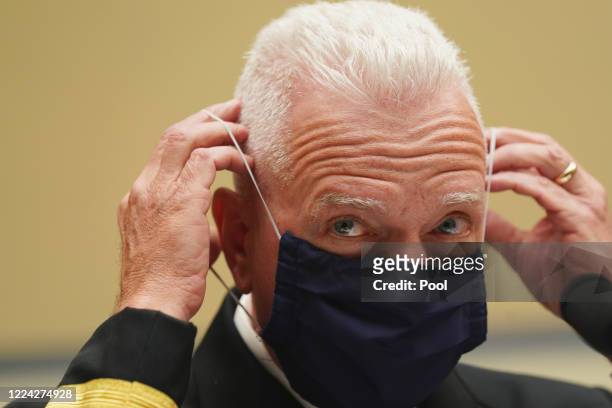 Assistant Secretary for Health and Human Services Admiral Brett P. Giroir adjusts his protective face mask as he testifies before a House Select...