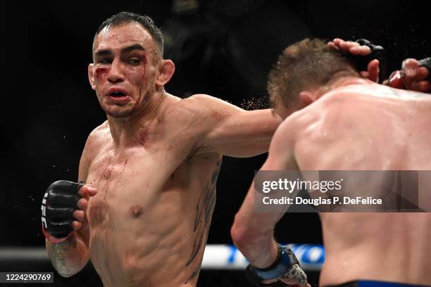 Tony Ferguson of the United States looks to punch Justin Gaethje of the United States in their Interim lightweight title fight during UFC 249 at...