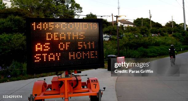 Sign displays "1405+ Covid-19 Deaths As 5/11, Stay Home!" at the Atlanta Beltline near Piedmont Park as the coronavirus pandemic continues on May 11,...