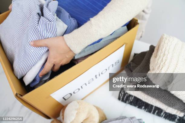 giving and sharing - clothing donation stock pictures, royalty-free photos & images