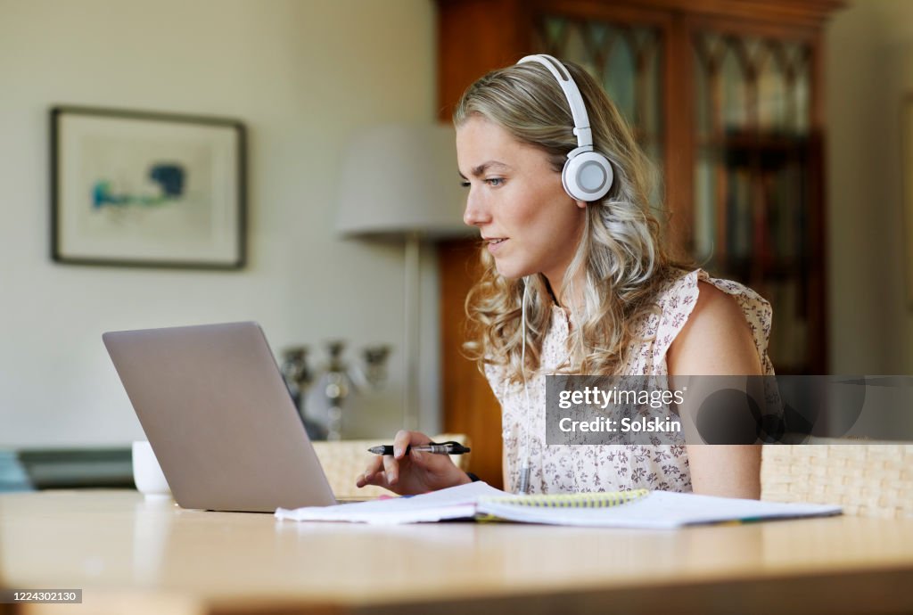 Young woman making schoolwork from home