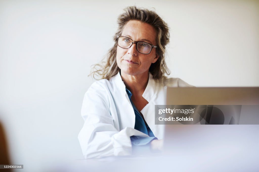 Female doctor using laptop