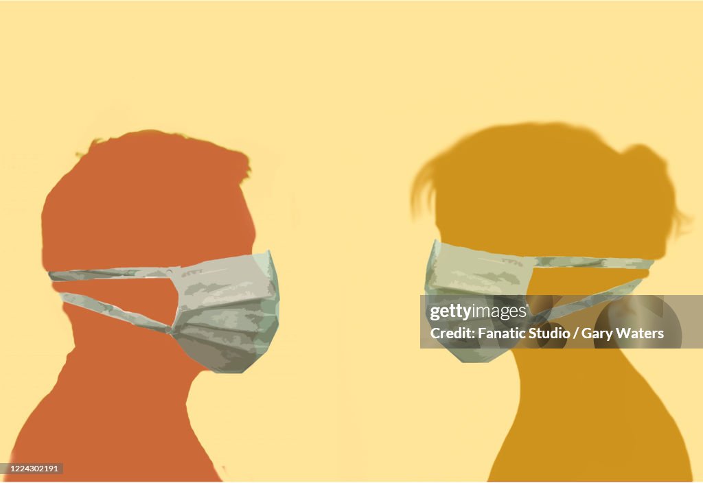 Profile image of a man and woman facing each other wearing surgical face masks depicting protection