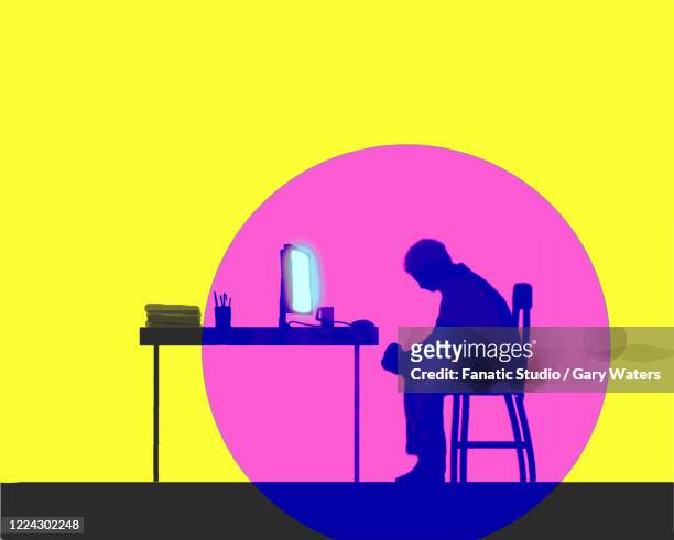 depressed man sitting in front of glowing computer screen. - loneliness stock illustrations