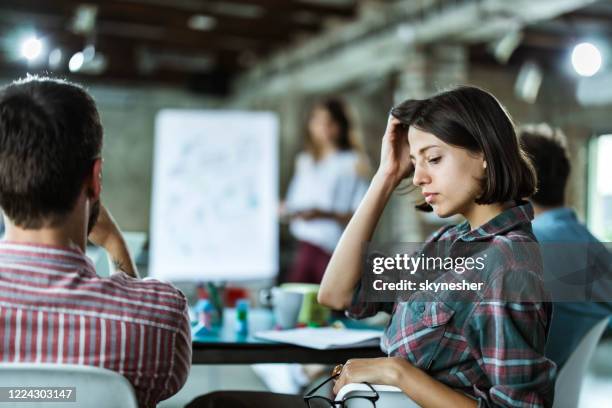 creative woman on a presentation with her colleagues in the office. - boring meeting stock pictures, royalty-free photos & images