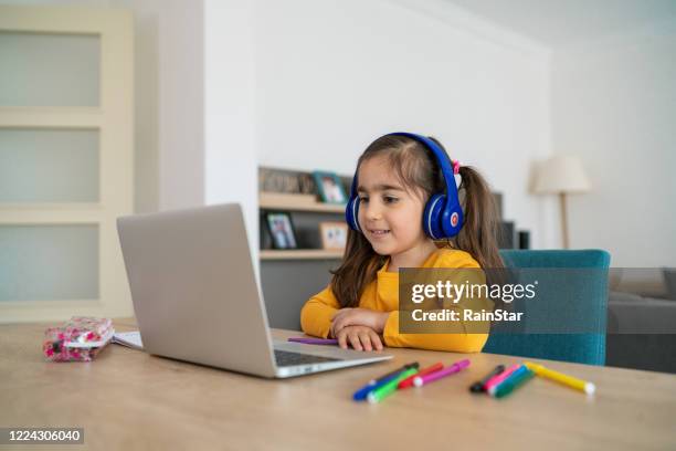 little girl homeschooling and distance learning at home - secondary school covid stock pictures, royalty-free photos & images