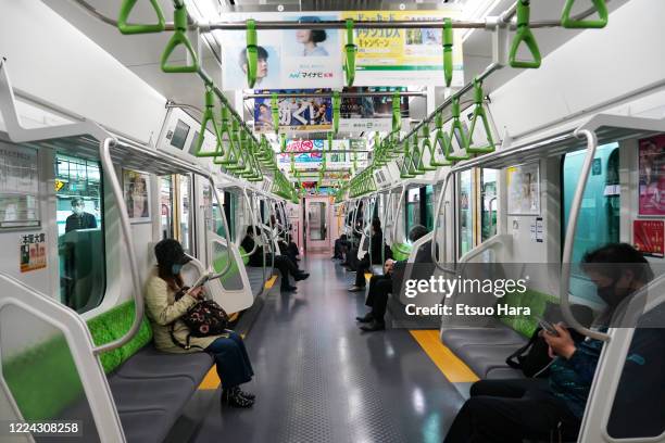 Few people wearing face masks are seen on a JR Yamanote Line amid the coronavirus pandemic on May 12, 2020 in Tokyo, Japan.