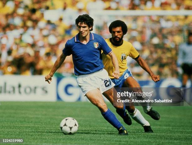 Paolo Rossi of Italy competes for the ball with Leovegildo Lins da Gama Júnior of Brazil during the World Cup Spain 1982 match between Italy and...