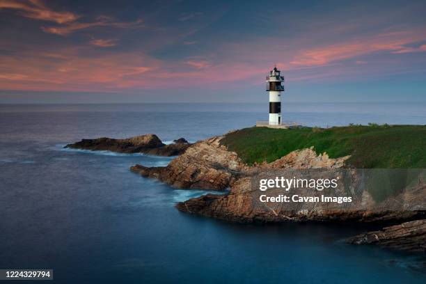 lighthouse at sunset in galicia - beacon stock pictures, royalty-free photos & images