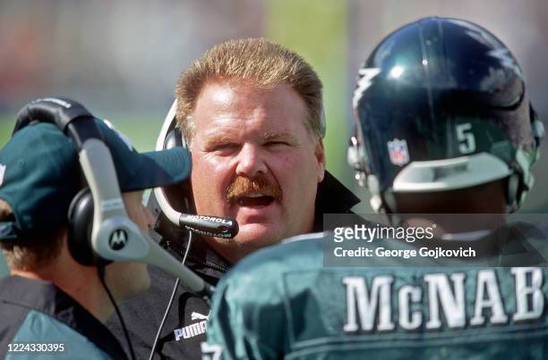 Head coach Andy Reid of the Philadelphia Eagles talks to quarterback Donovan McNabb on the sideline during a game against the Washington Redskins at...