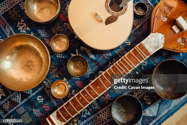 traditional instruments: sitar and portuguese guitar and singing bowls - veena stock pictures, royalty-free photos & images