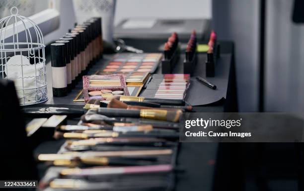 make up palettes and brushes on a dressing table - vanity table stock pictures, royalty-free photos & images