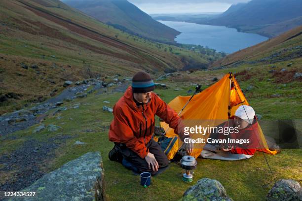 couple camping on the way up to scafell pike in the lake district - copeland england stock pictures, royalty-free photos & images