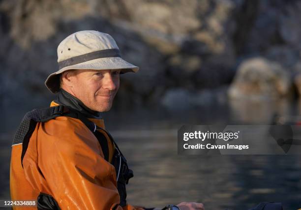 portrait of man on a sea kayak in eastern greenland - geologist ストックフォトと画像