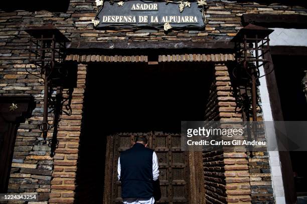Antonio, worker at the Asador Despensa de la Alpujarra restaurant, closed due to the coronavirus crisis on May 11, 2020 in Trevélez, Spain. The...