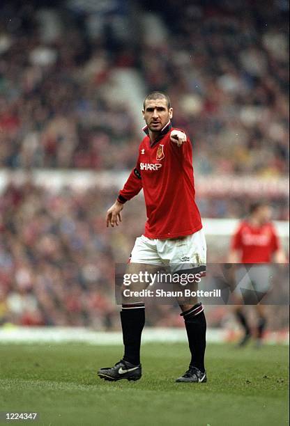 Eric Cantona of Manchester United indicates to his team mates during an FA Carling Premiership match against Coventry City at Old Trafford in...