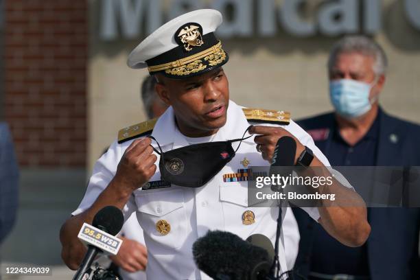 Vice Admiral Jerome Adams, U.S. Surgeon General, takes off a protective mask while speaking during a 'Wear A Mask' tour stop in Dalton, Georgia,...