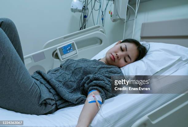 having an iv drip at hospital - vitamin iv stock pictures, royalty-free photos & images