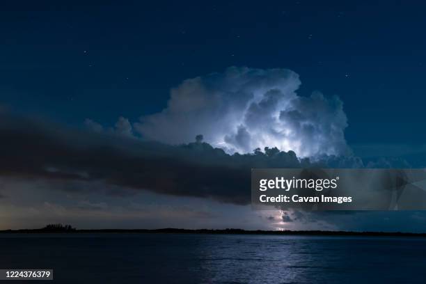 massive lightning strike on florida coast at night long exposure - lightning strike imagens e fotografias de stock