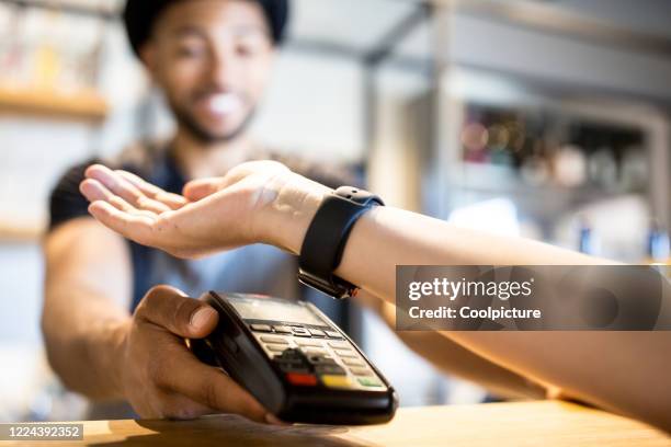 young owner of a hipster café. - watch payment stock pictures, royalty-free photos & images