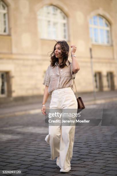 Masha Sedgwick wearing Nobi Talai blouse, Agneel bag, Closed jeans and Coach sneaker on May 06, 2020 in Berlin, Germany.
