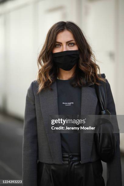 Masha Sedgwick wearing Acne Studios shirt, Maison Margiela blazer, Set pants and Miu Miu bag on May 06, 2020 in Berlin, Germany.