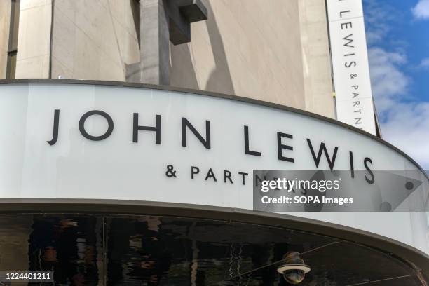 Sign on the Oxford Street branch of John Lewis, as the Partnership is poised to: cut jobs, axe the annual bonus, close one of its London headquarters...