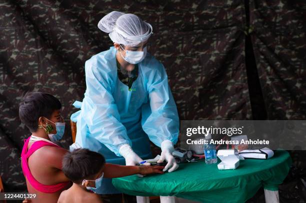 An Armed Forces doctor examines Yanomami indigenous children of Surucucu amidst the coronavirus pandemic at the 4 Special Border Platoon on July 01,...