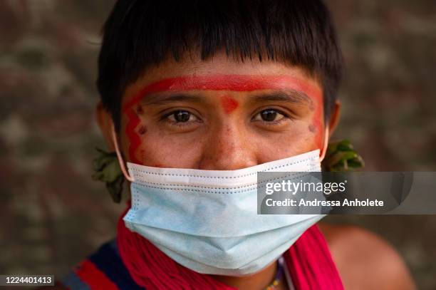 Yanomami woman wears protective mask to receive health care during the Yanomami / Raposa Serra do Sol Mission amidst the coronavirus pandemic at the...