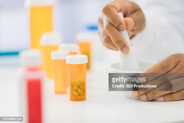 pharmacist mixed medication in compounding pharmacy - mortar and pestle stock pictures, royalty-free photos & images
