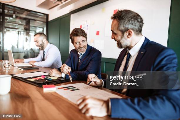 latino bankers negotiating about new partnership and cooperation - wealth management stock pictures, royalty-free photos & images