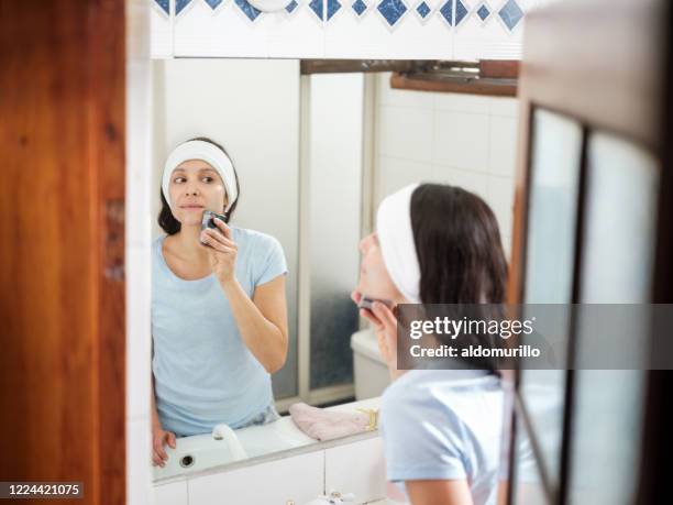 pretty latin woman washing face with sustainable soap - plastic free stock pictures, royalty-free photos & images