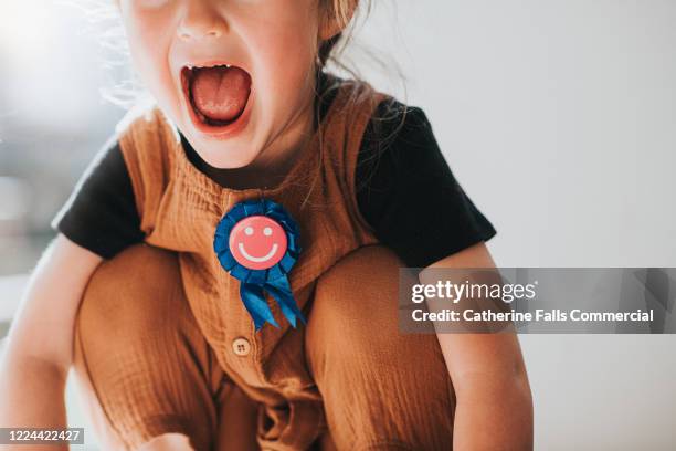 child wearing a rosette - receiving trophy stock pictures, royalty-free photos & images