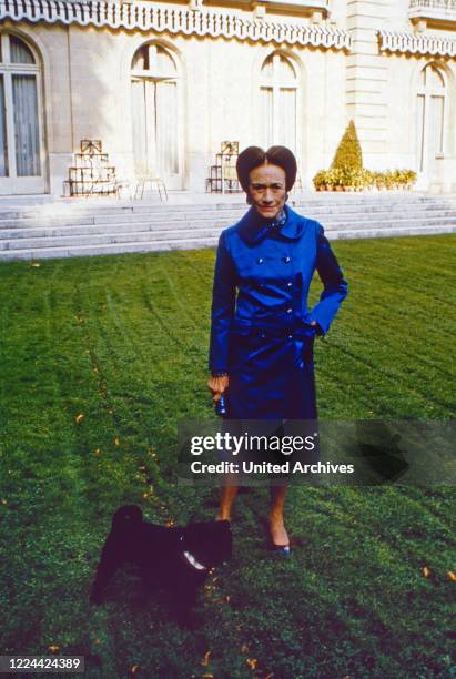 The Duchess of Windsor, Wallis Simpson, with her pug dogs at her home in Bois de Boulogne near Paris, France 1974.